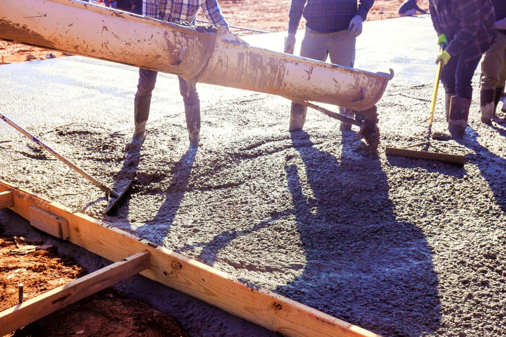Construction,Crew,Expertly,Pours,Fresh,Concrete,Slab,To,Create,Strong