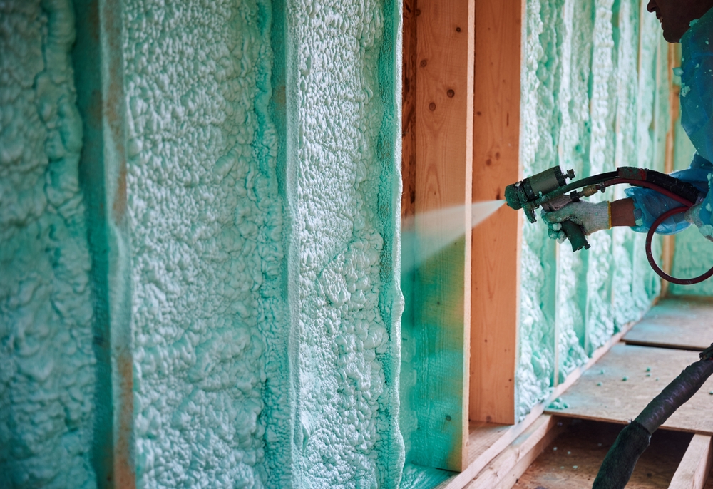 Builder,Insulating,Wooden,Frame,House.,Close,Up,View,Of,Man