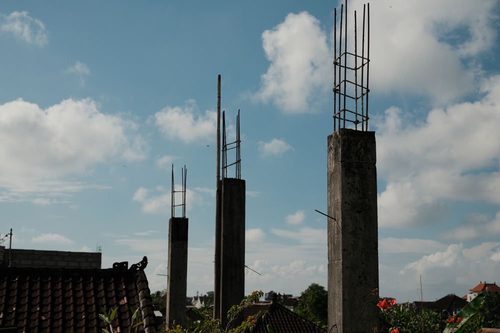 Three,Concrete,Pillars,With,Exposed,Rebar,Stand,Tall,At,A