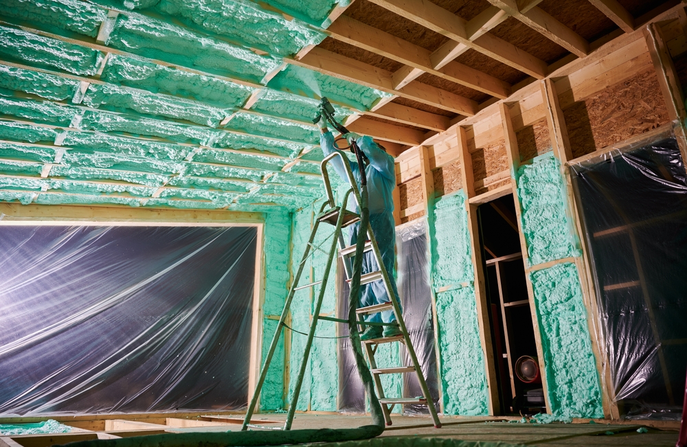 Male,Builder,Insulating,Wooden,Frame,House.,Man,Worker,Spraying,Polyurethane