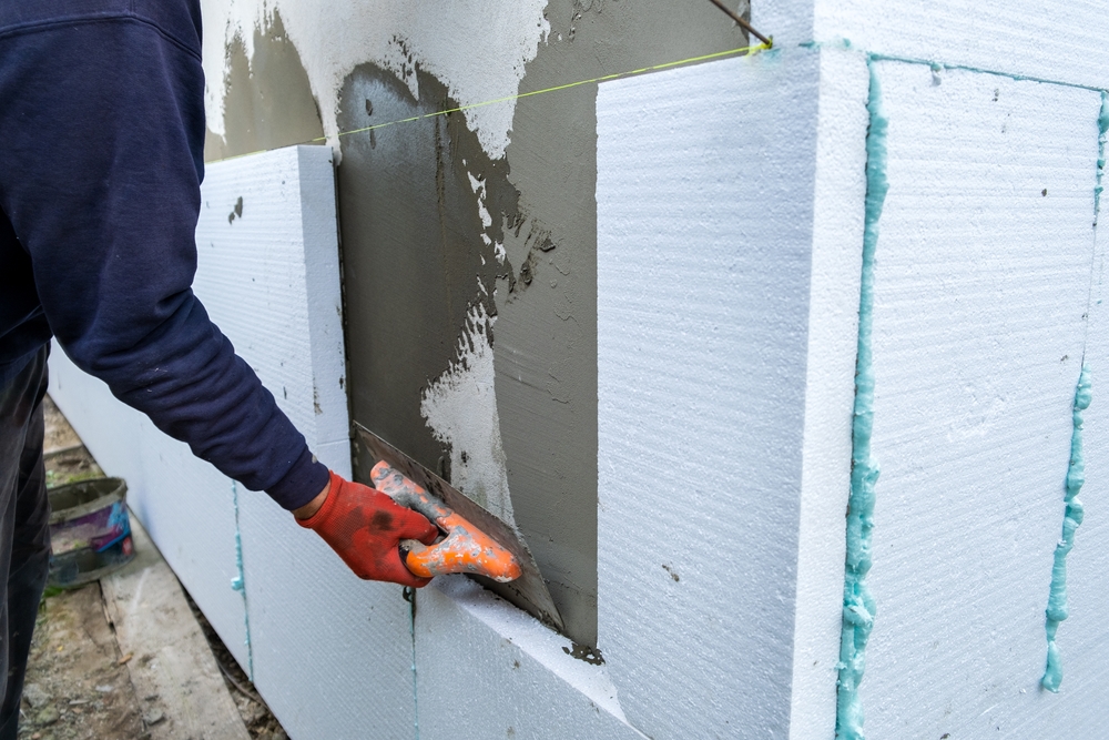 Construction,Worker,Installing,Styrofoam,Insulation,Sheets,On,House,Facade,Wall