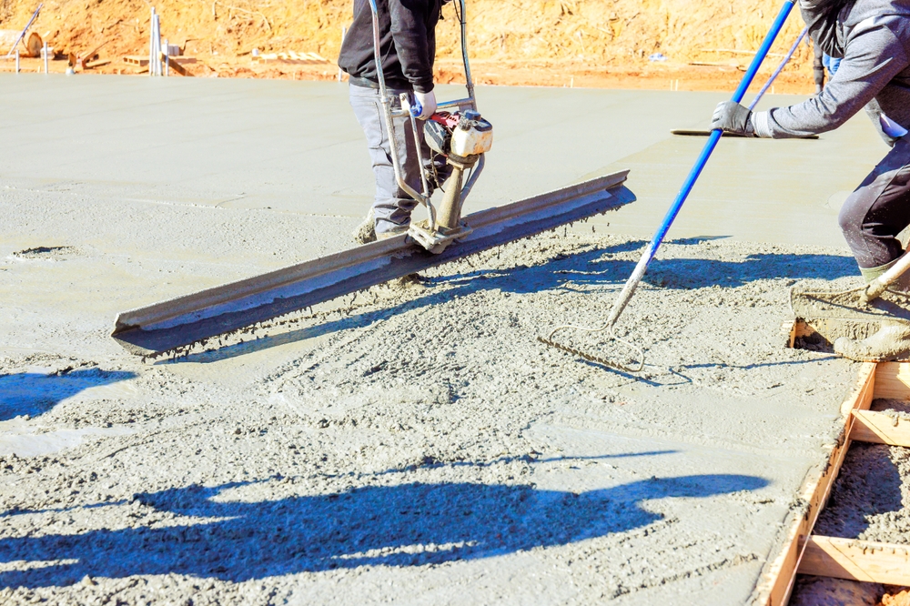 Workers,Smooth,Out,Newly,Poured,Concrete,,Preparing,Surface,For,Construction