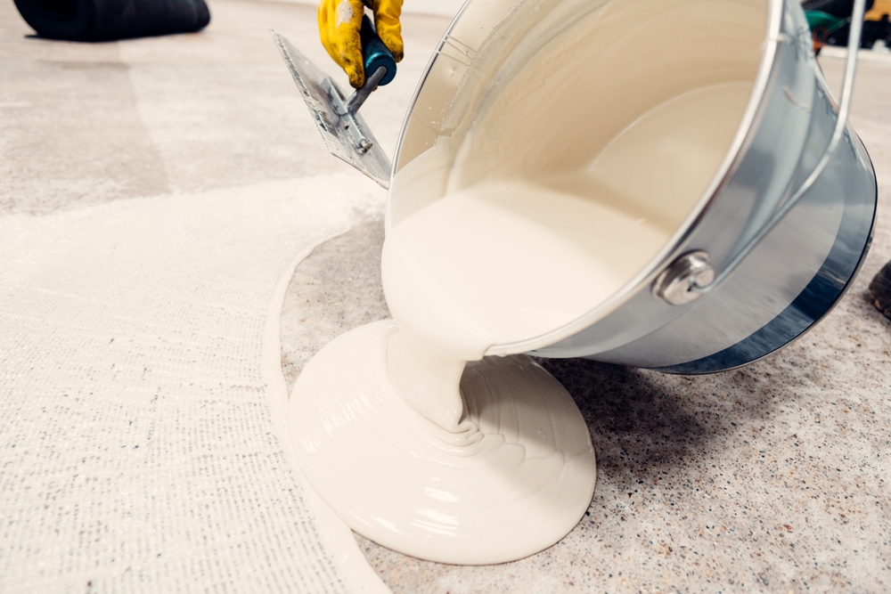 Construction,Worker,Is,Pouring,Self-leveling,Concrete,On,The,Floor,Covered