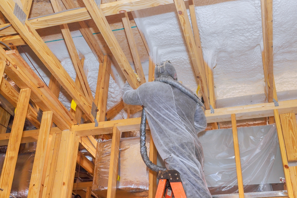 Contractor,In,Protective,Gear,Sprays,Thermal,Insulation,Onto,Ceiling,Beams